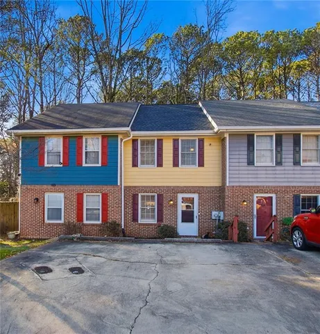 a front view of a residential apartment building with a yard