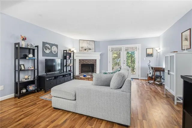 a living room with furniture flat screen tv and a fireplace