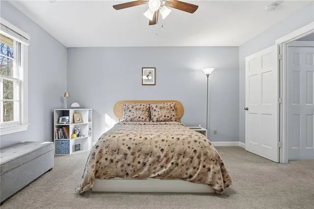 a bedroom with a large bed and a chandelier