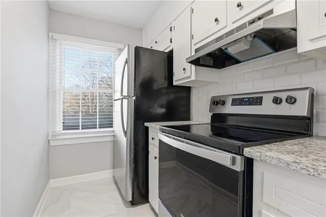 a kitchen with a stove and a refrigerator