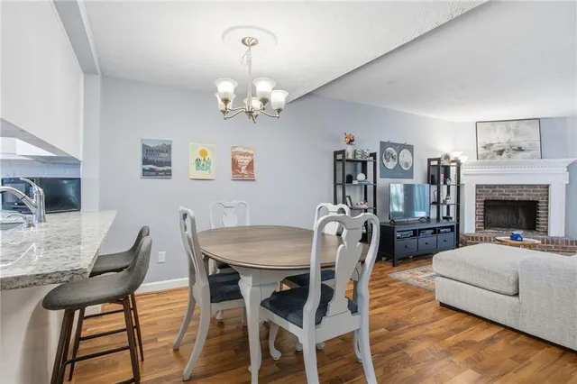 a view of a dining room with furniture and chandelier