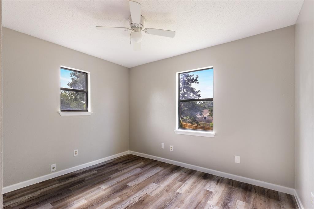 2820 Bois D'Arc Street Commerce, TX 75428 - Photo 21 of 40 a view of an empty room with a window and wooden floor