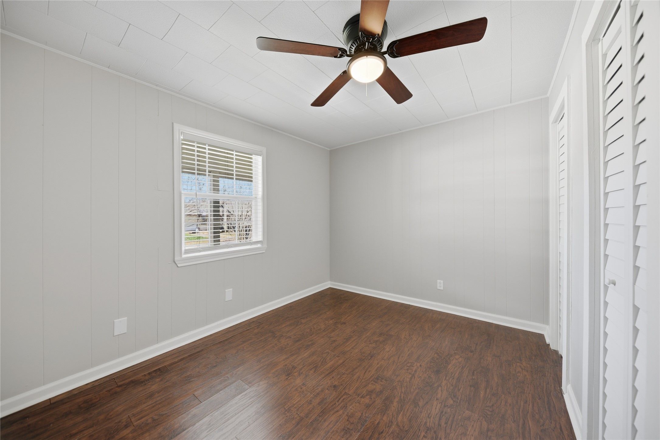 1702 Rampart Street Columbus, TX 78934 - Photo 15 of 38 an empty room with wooden floor fan and windows