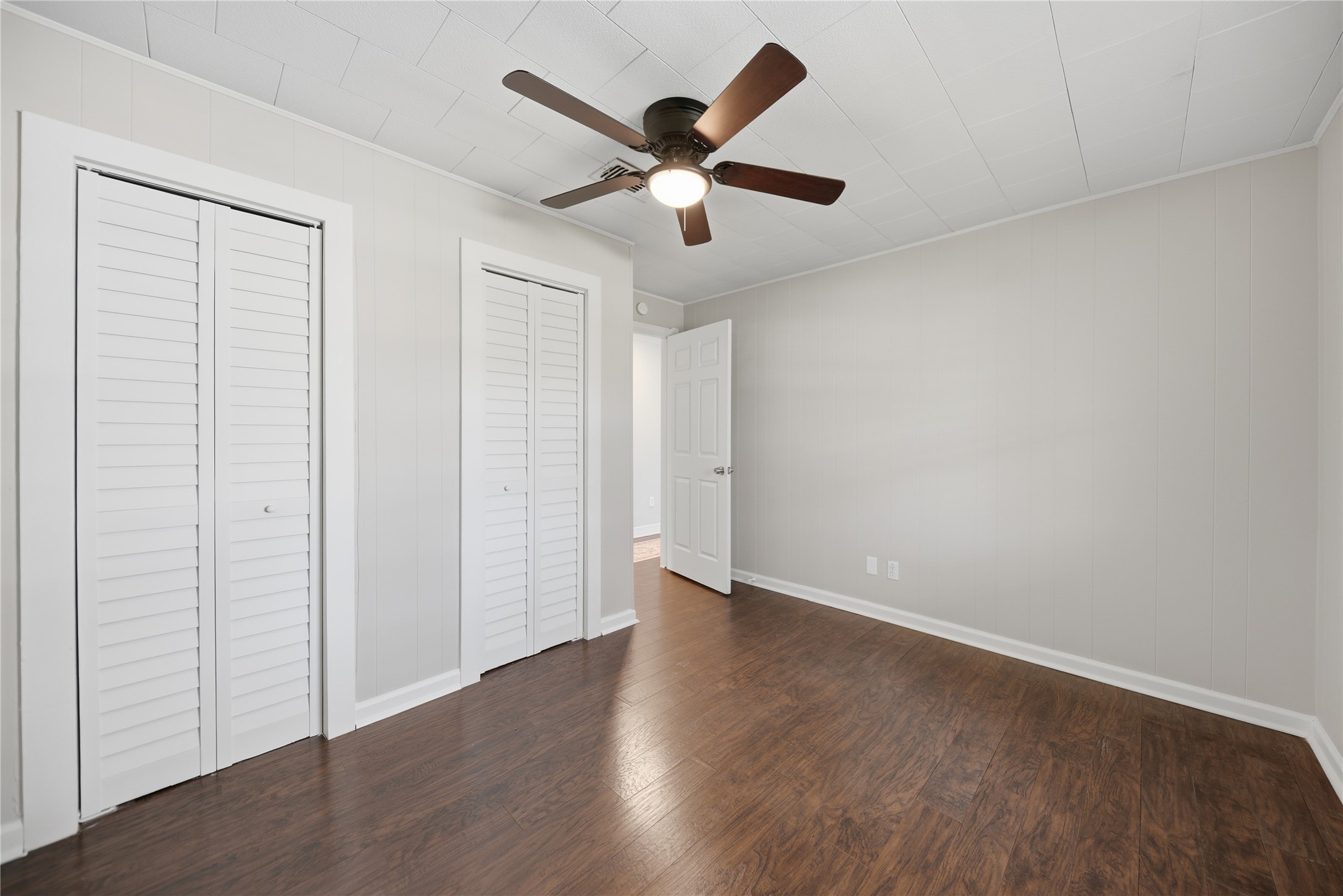 1702 Rampart Street Columbus, TX 78934 - Photo 16 of 38 an empty room with wooden floor and ceiling fan