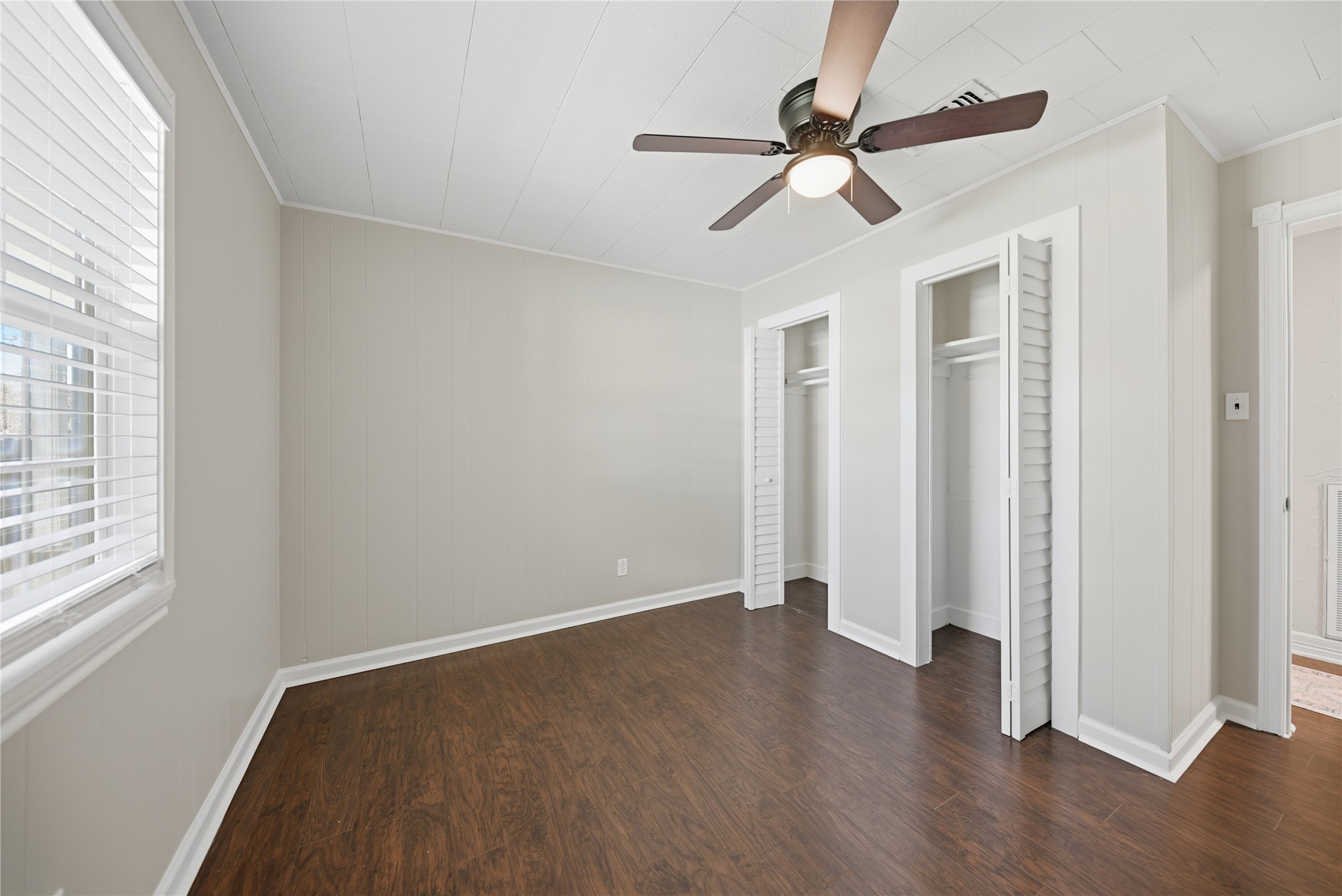 1702 Rampart Street Columbus, TX 78934 - Photo 17 of 38 an empty room with wooden floor fan and windows