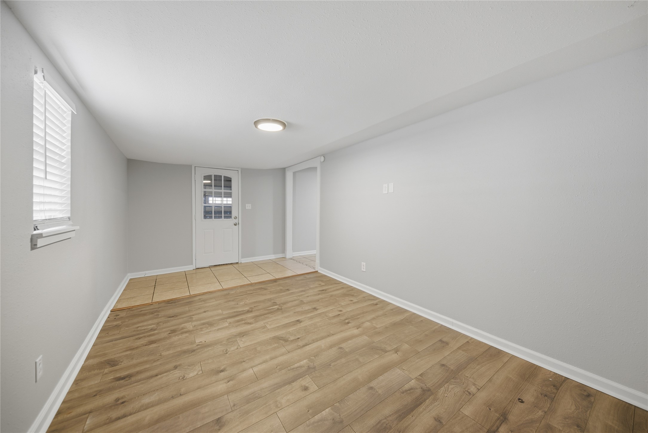 1702 Rampart Street Columbus, TX 78934 - Photo 36 of 38 wooden floor in an empty room with a window