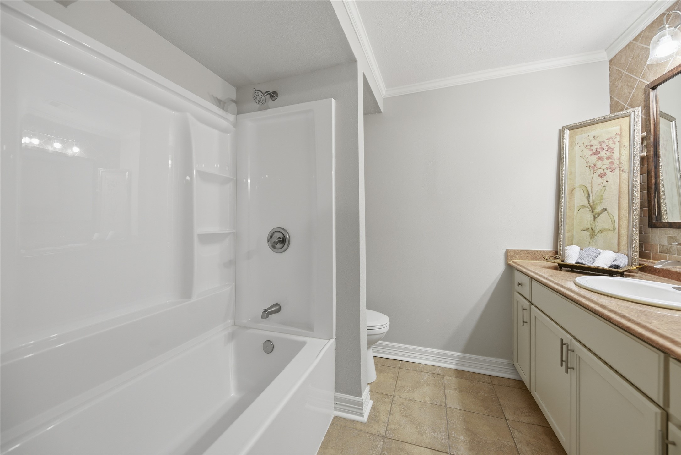 1702 Rampart Street Columbus, TX 78934 - Photo 6 of 38 a bathroom with a granite countertop sink a toilet and bathtub