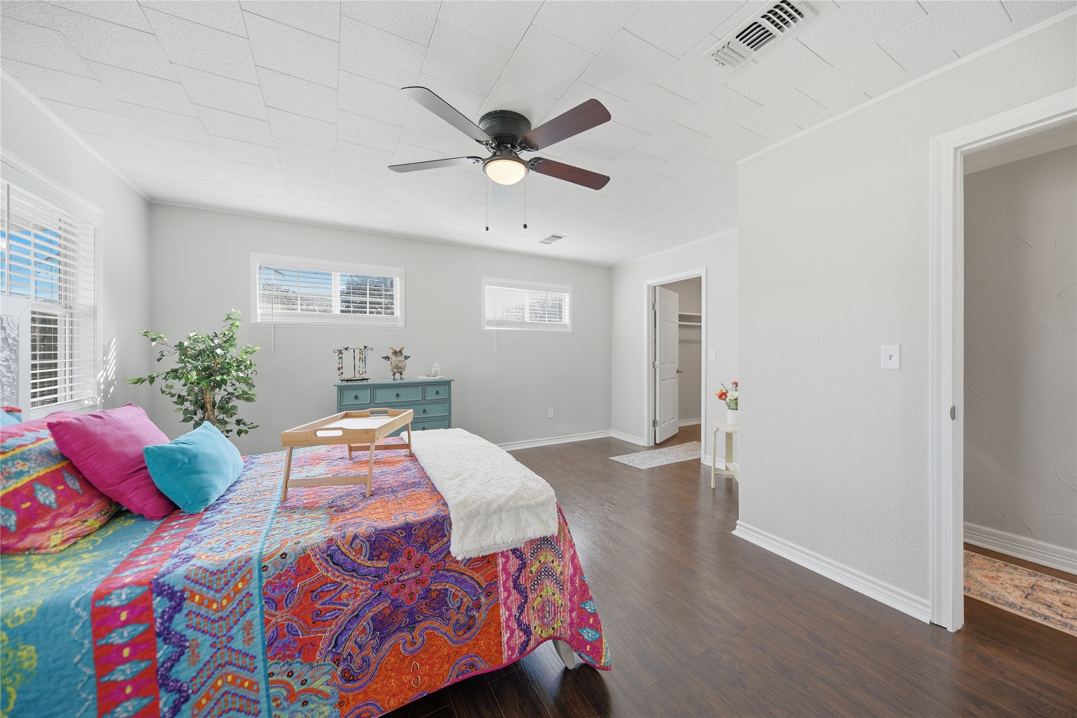1702 Rampart Street Columbus, TX 78934 - Photo 9 of 38 a bedroom with a bed and a chandelier