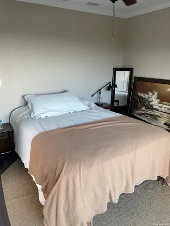 a bedroom with a bed and a large window
