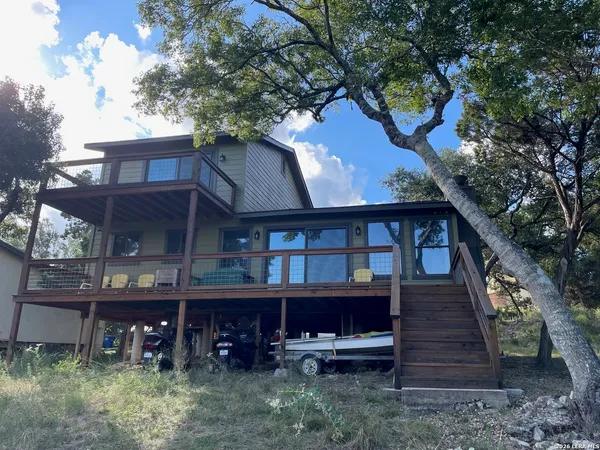a view of a wooden house with a yard