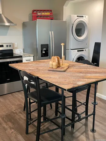a dining table with chairs and washing machine