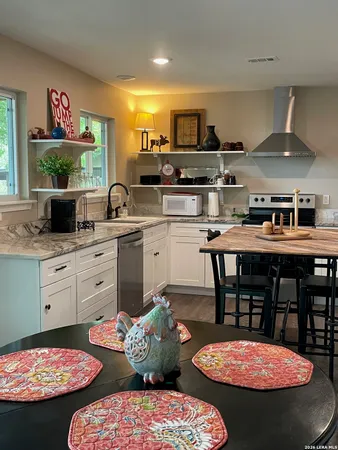 a kitchen with stainless steel appliances kitchen island granite countertop a sink and cabinets