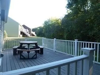 a living room with furniture and a dining table with wooden floor