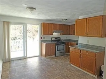 a kitchen with a refrigerator and a stove top oven