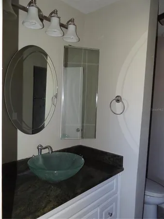 a bathroom with a sink and mirror