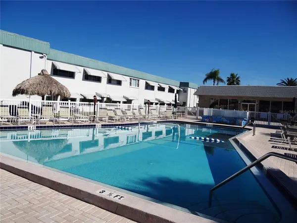 a view of a swimming pool with a table and chairs