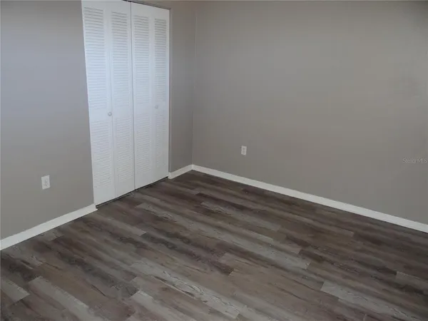 an empty room with wooden floor
