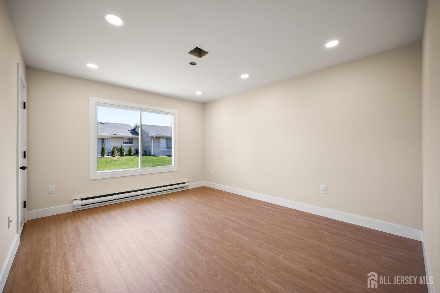 701 Croydon Road, Unit A Monroe Township, NJ 08831 - Photo 24 of 34 an empty room with wooden floor and a window