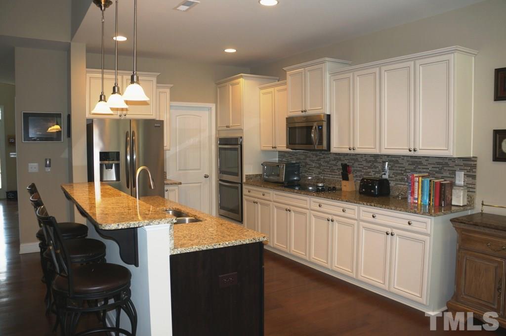 2316 Everstone Road Wake Forest, NC 27587 - Photo 7 of 25 Double Ovens, Huge walk in pantry, built in microwave, gorgeous granite.....this kitchen has it all!