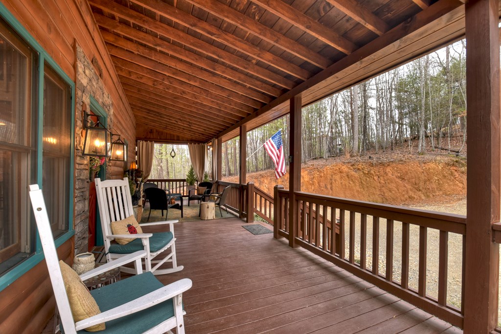 54 Channing Ridge Road Morganton, GA 30560 - Photo 21 of 54 a view of a chairs and table in patio with wooden floor