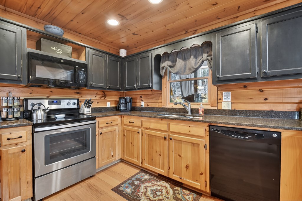 54 Channing Ridge Road Morganton, GA 30560 - Photo 32 of 54 a kitchen with stainless steel appliances granite countertop a stove sink and cabinets