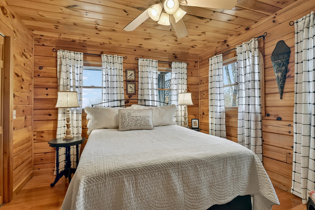 54 Channing Ridge Road Morganton, GA 30560 - Photo 34 of 54 a bedroom with a bed and a walk in closet