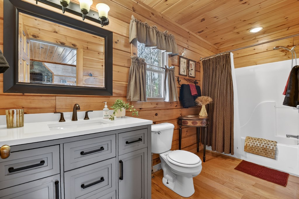 54 Channing Ridge Road Morganton, GA 30560 - Photo 36 of 54 a bathroom with a granite countertop toilet sink and mirror