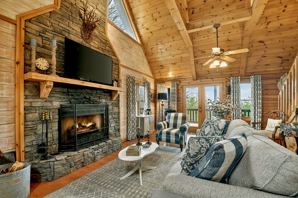 54 Channing Ridge Road Morganton, GA 30560 - Photo 6 of 54 a living room with furniture a flat screen tv and a fireplace