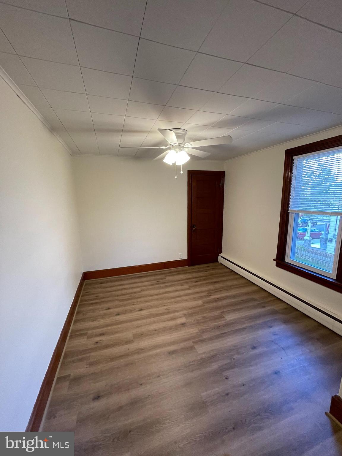 27 West High Street Hummelstown, PA 17036 - Photo 11 of 17 a view of an empty room with wooden floor and a window