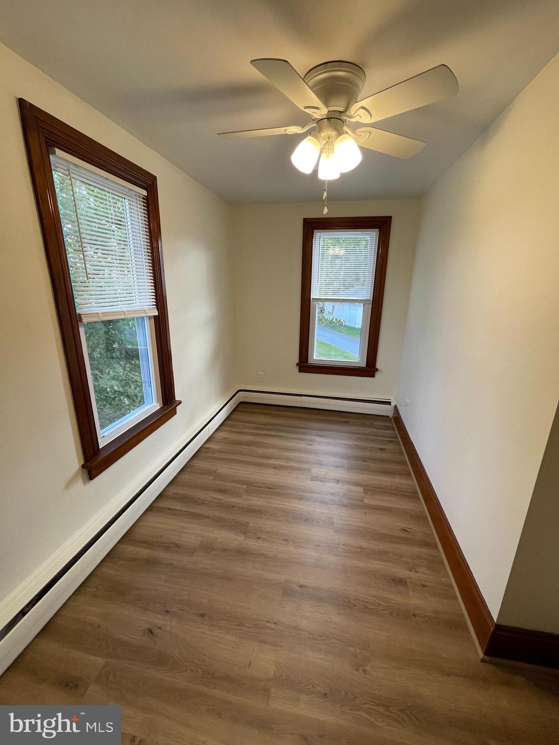 27 West High Street Hummelstown, PA 17036 - Photo 12 of 17 a view of an empty room with wooden floor and a window