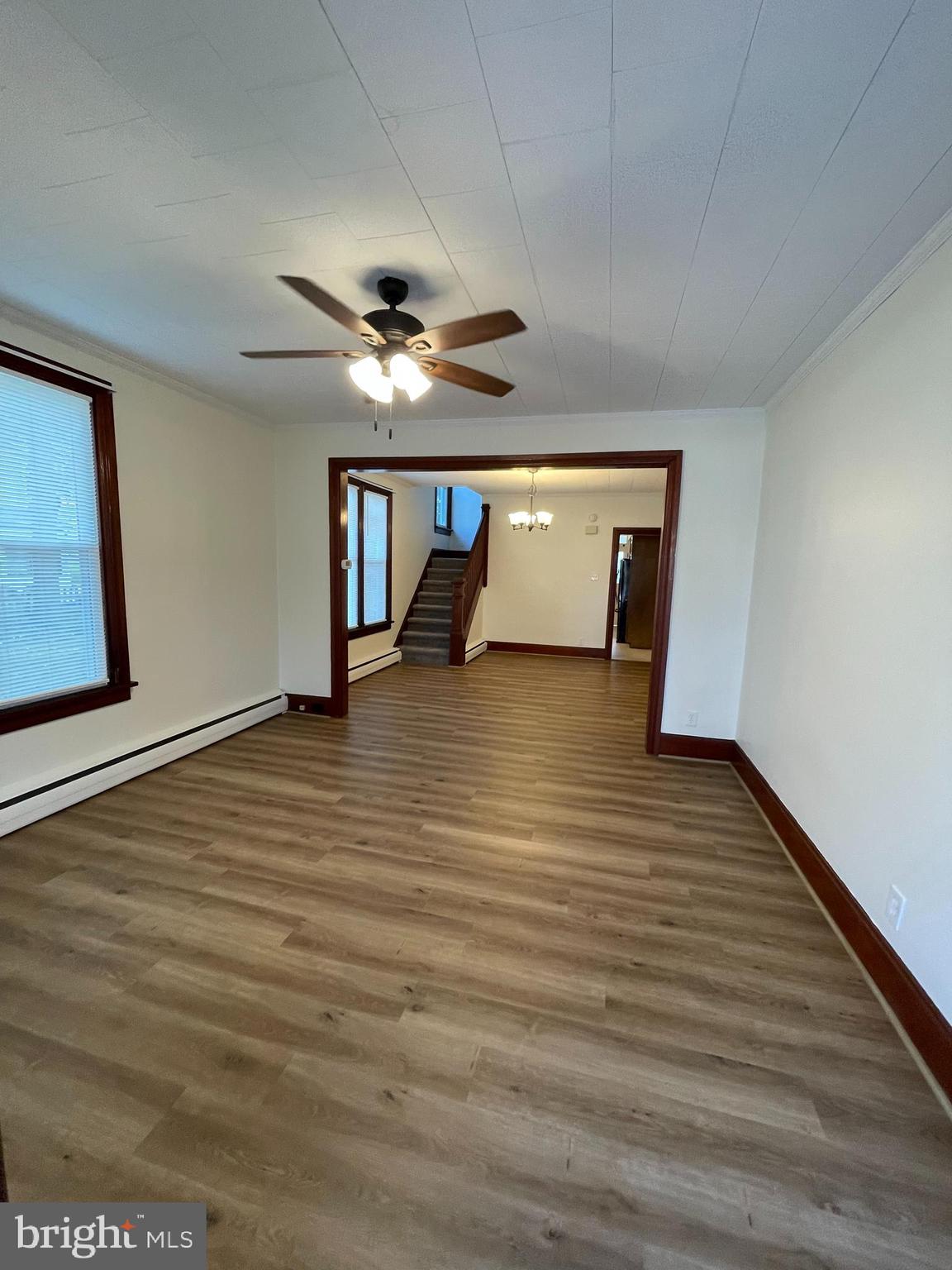 27 West High Street Hummelstown, PA 17036 - Photo 2 of 17 wooden floor in an empty room with a window