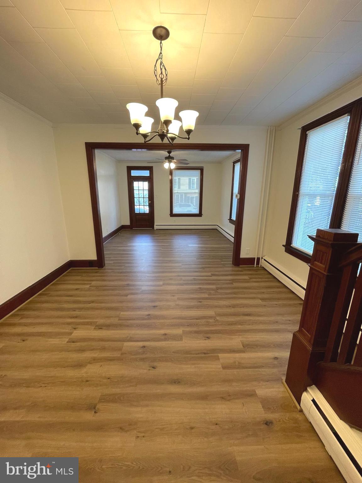 27 West High Street Hummelstown, PA 17036 - Photo 3 of 17 a view of a livingroom with wooden floor and chandelier