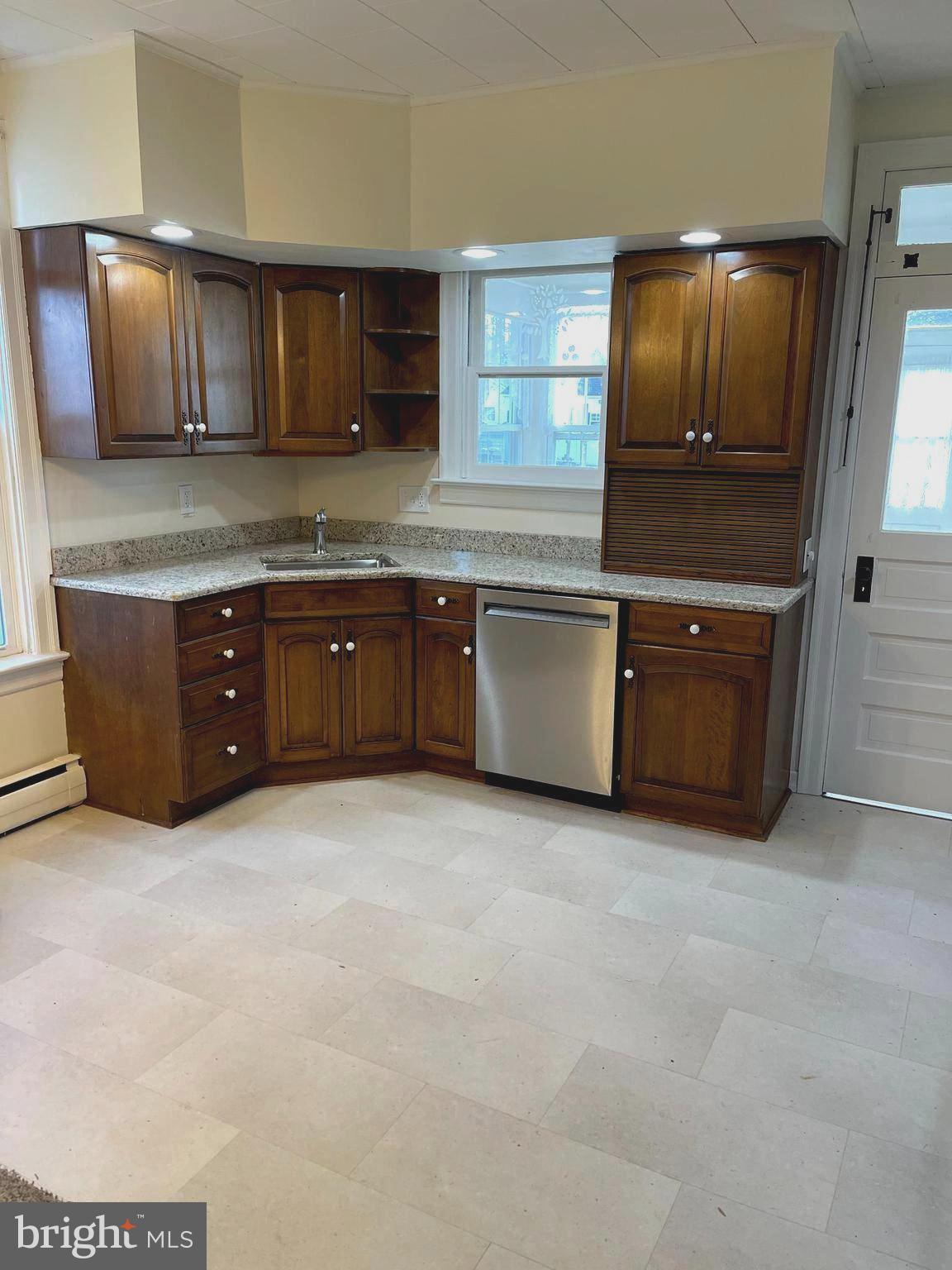 27 West High Street Hummelstown, PA 17036 - Photo 4 of 17 a kitchen with stainless steel appliances granite countertop a stove a sink and a microwave