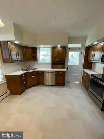 a large kitchen with a stove and a sink
