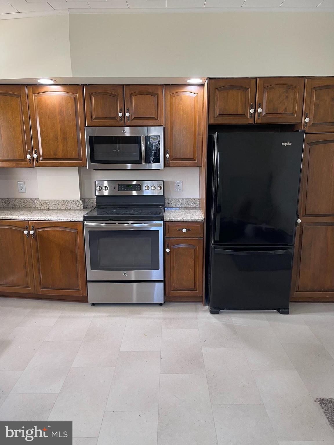 27 West High Street Hummelstown, PA 17036 - Photo 6 of 17 a kitchen with granite countertop a stove and a microwave