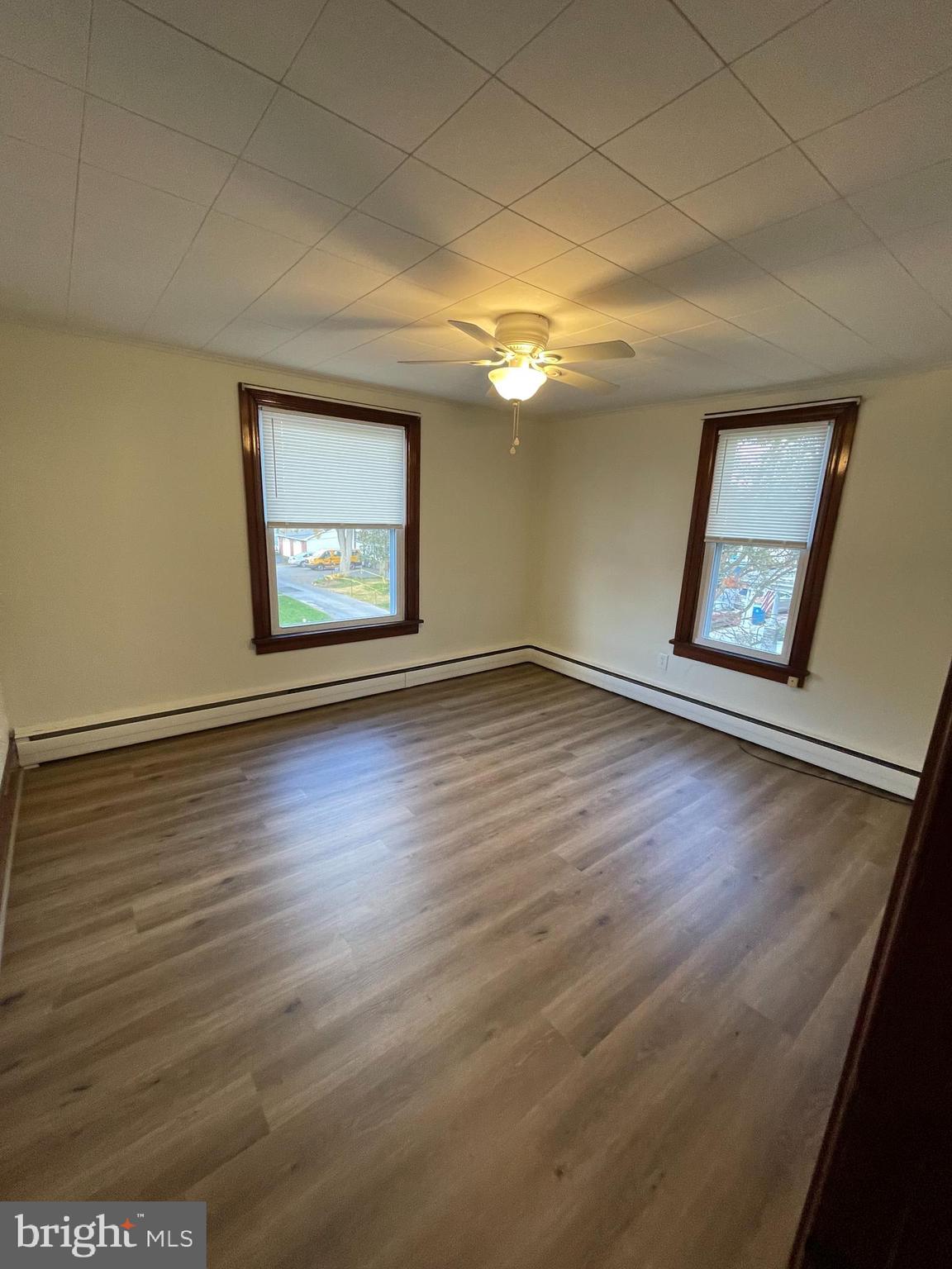27 West High Street Hummelstown, PA 17036 - Photo 10 of 17 an empty room with wooden floor and windows