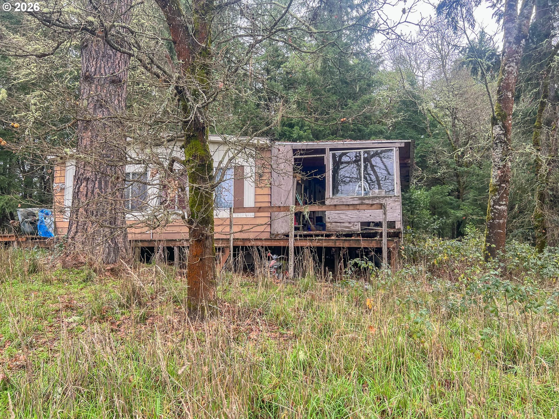 1698 Doerner Road Roseburg, OR 97471 - Photo 13 of 18 a view of house with outdoor seating and covered with trees