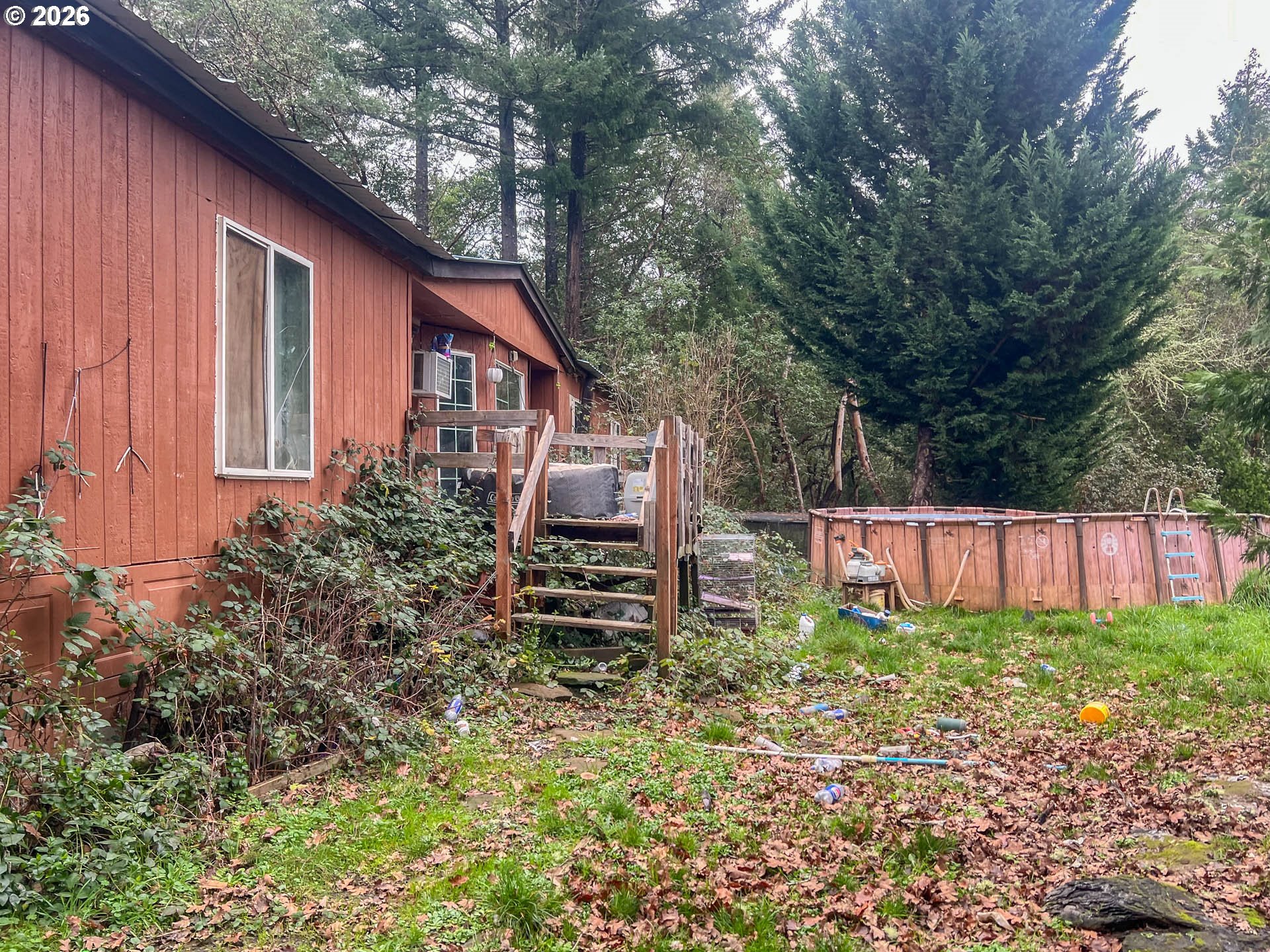 1698 Doerner Road Roseburg, OR 97471 - Photo 7 of 18 a view of a backyard with potted plants and large tree