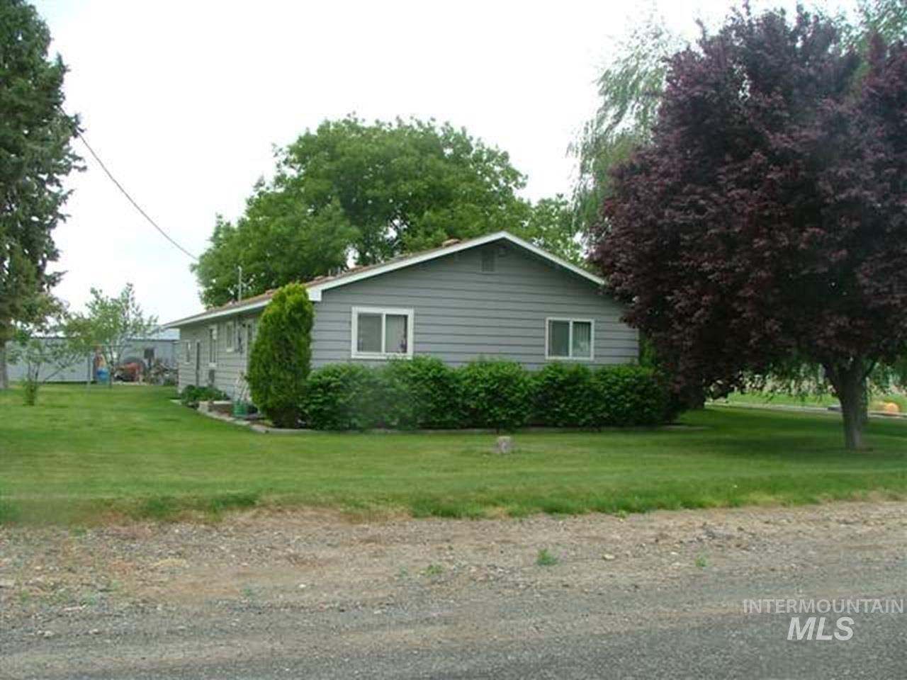 721 Mendiola Road Nyssa, OR 97913 - Photo 3 of 16 Ranch-style exterior with gray horizontal siding, white trim, and a low-sloping roof