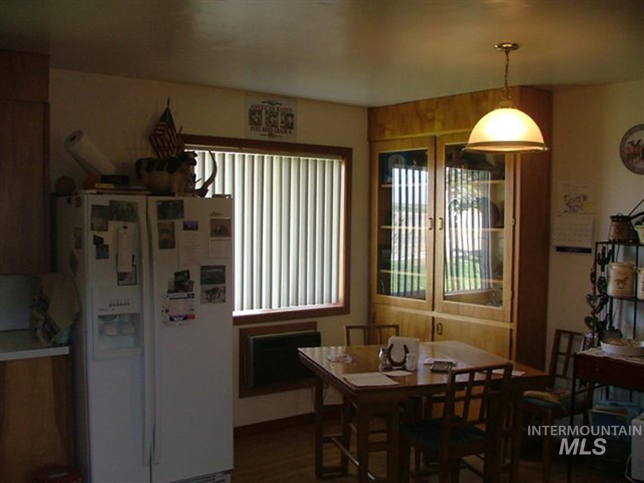 721 Mendiola Road Nyssa, OR 97913 - Photo 6 of 16 Dining area featuring a built-in corner cabinet with glass-front doors