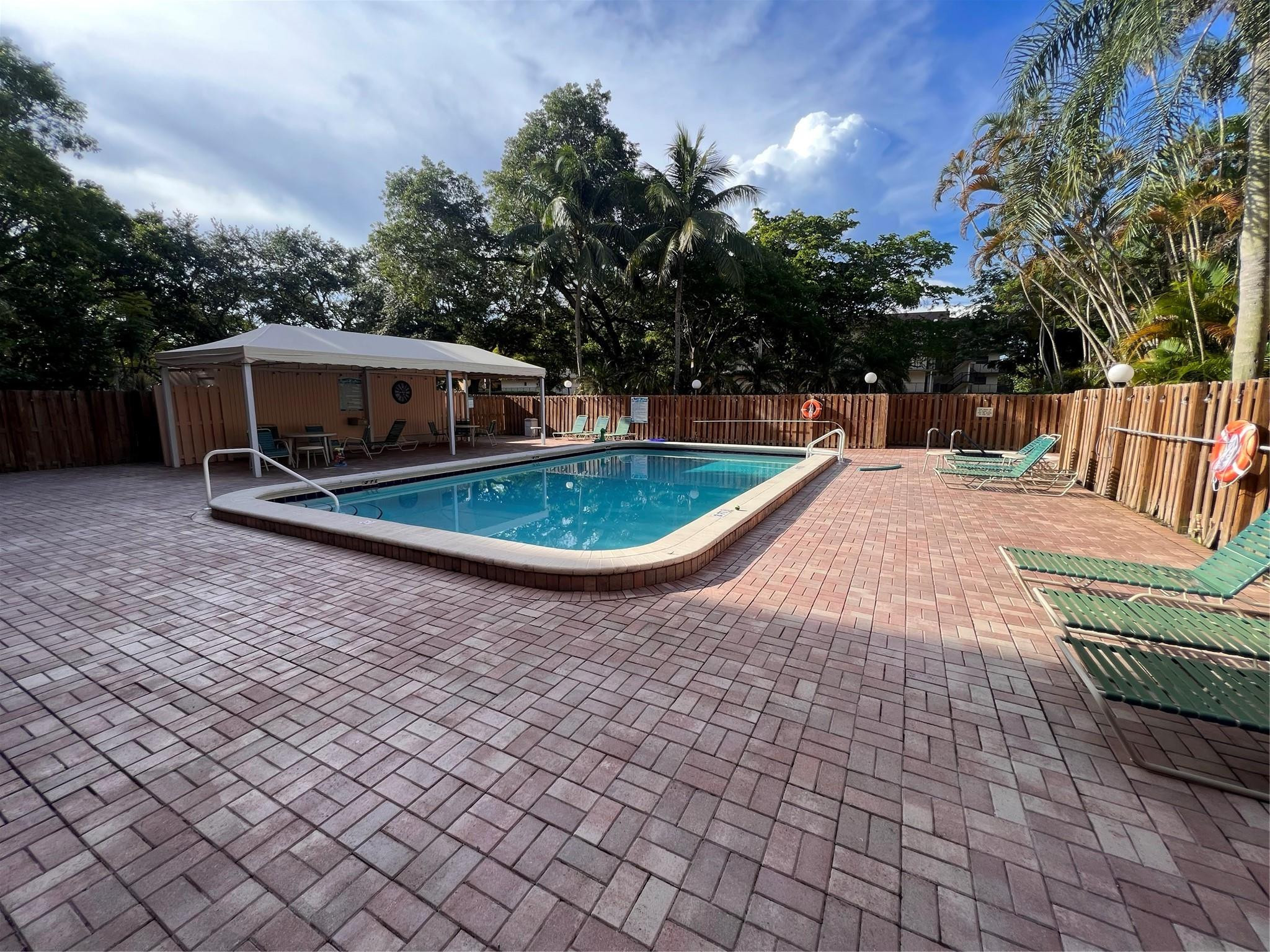 6800 Cypress Road, Unit 413 Plantation, FL 33317 - Photo 5 of 10 a backyard of a house with table and chairs