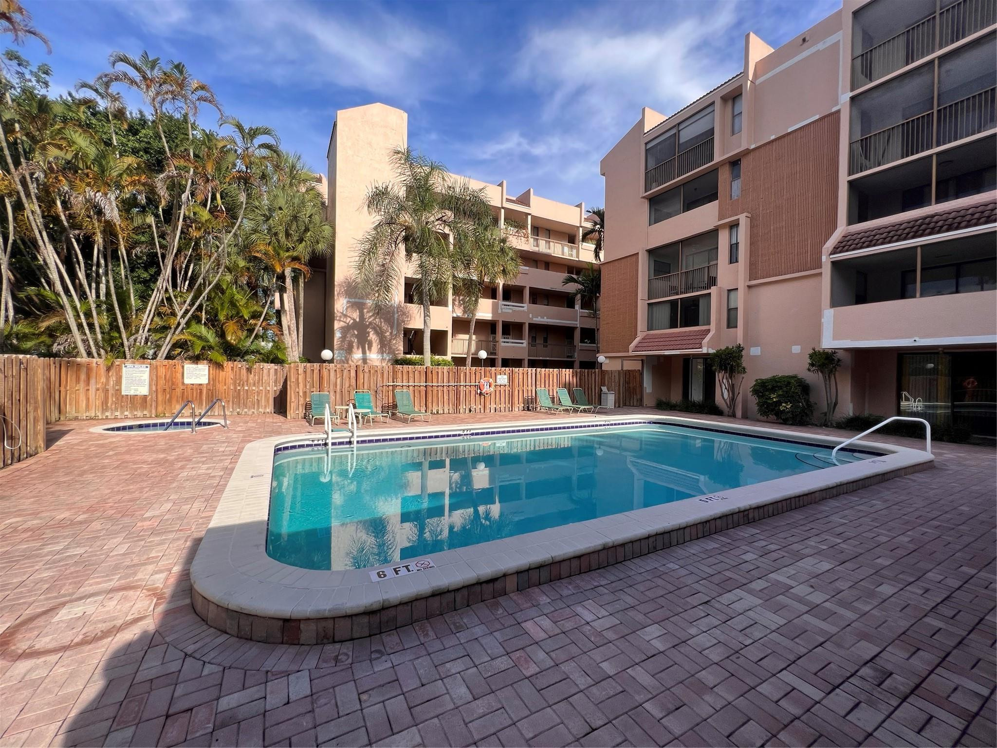 6800 Cypress Road, Unit 413 Plantation, FL 33317 - Photo 6 of 10 a view of a large building with swimming pool and sitting area
