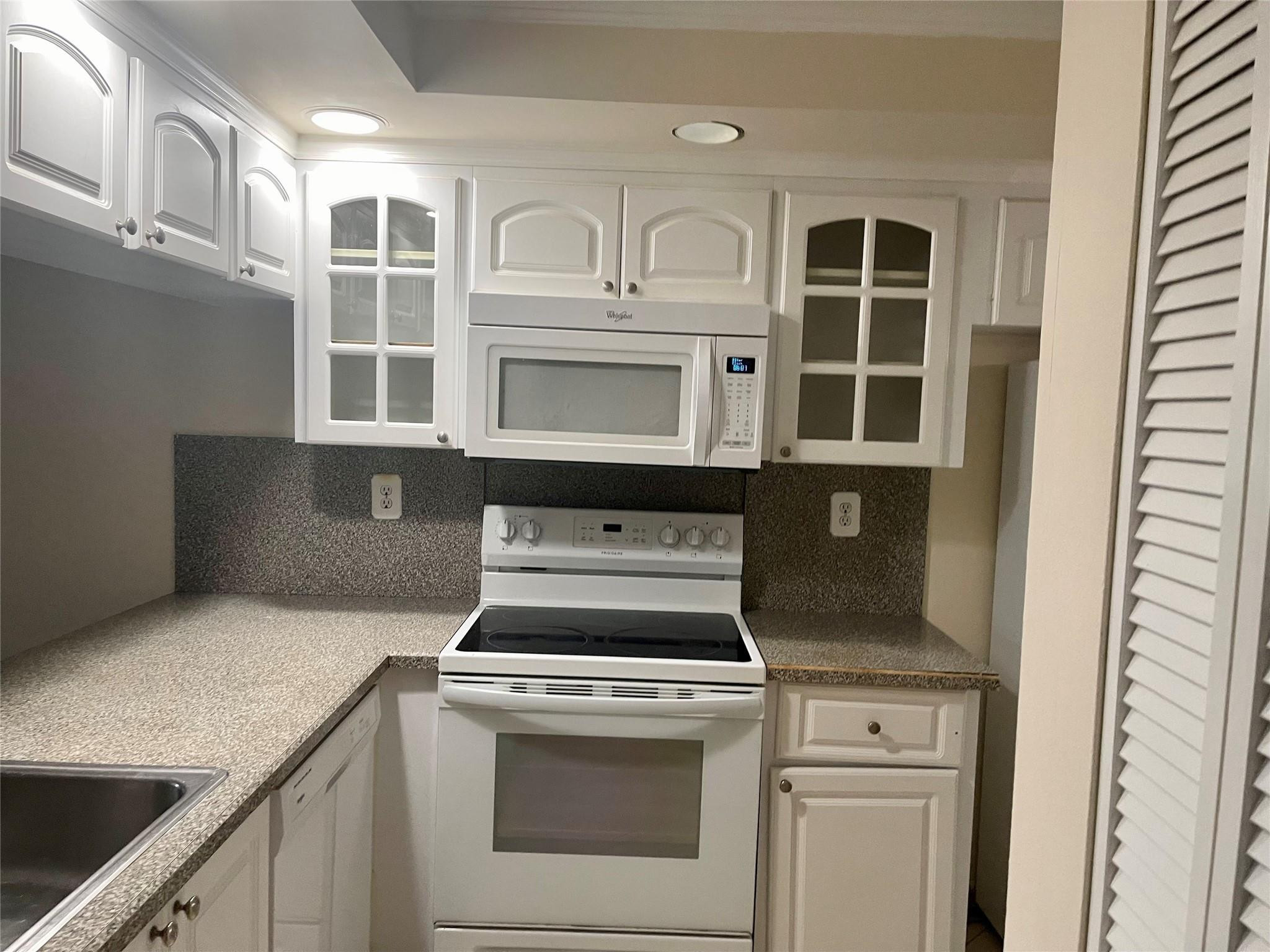 6800 Cypress Road, Unit 413 Plantation, FL 33317 - Photo 8 of 10 a view of a kitchen with a stove top oven