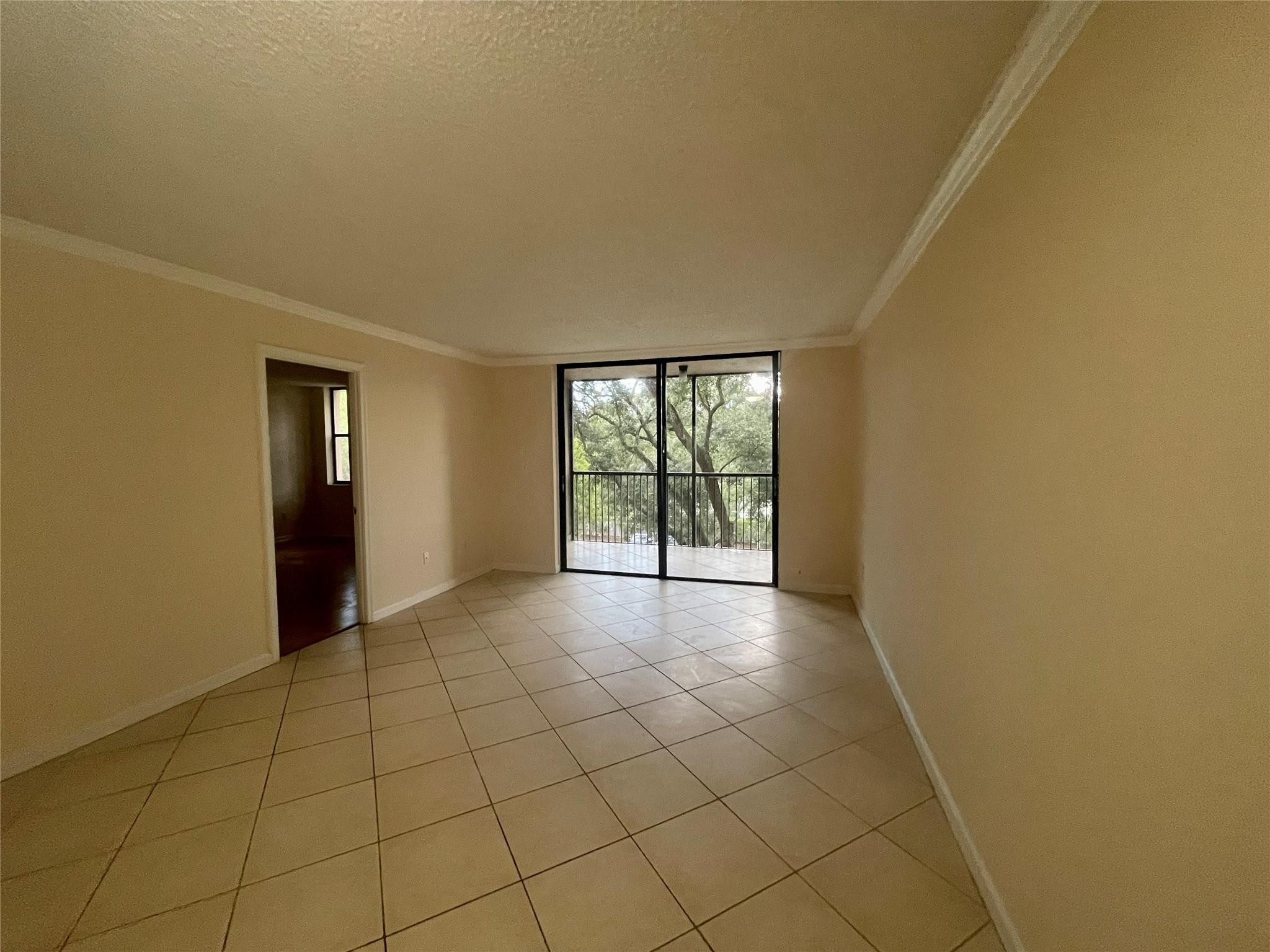 6800 Cypress Road, Unit 413 Plantation, FL 33317 - Photo 9 of 10 a view of an empty room with glass door