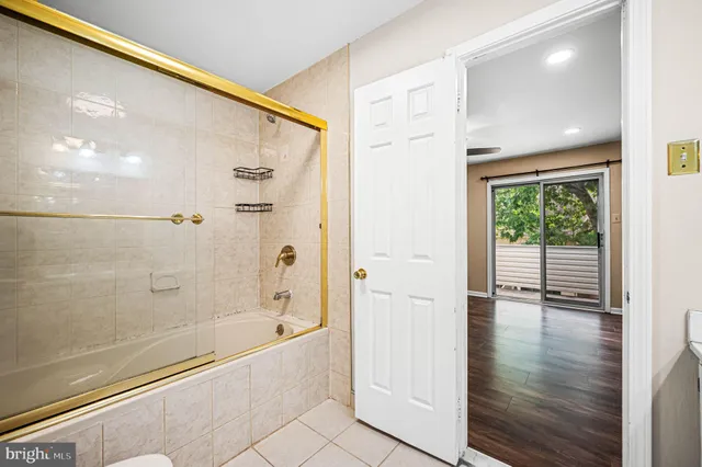 a view of room with window ceiling fan and hardwood floor