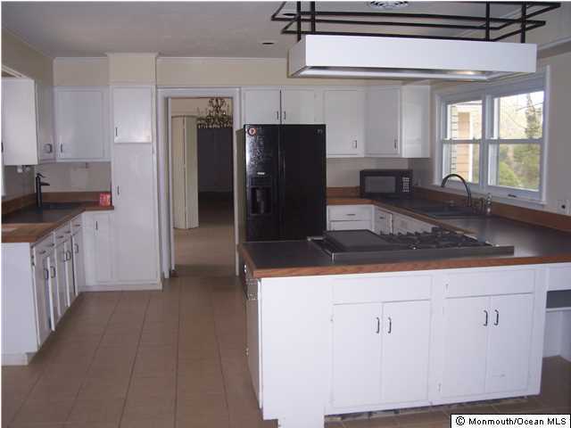 84 Rumson Road Rumson, NJ 07760 - Photo 4 of 5 a kitchen with stainless steel appliances granite countertop a refrigerator and a sink