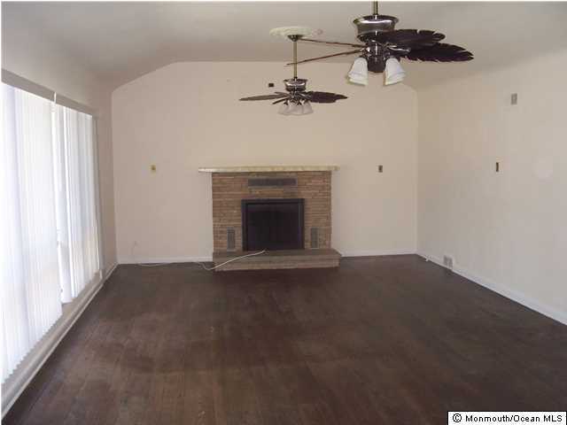 84 Rumson Road Rumson, NJ 07760 - Photo 5 of 5 an empty room with windows and fireplace