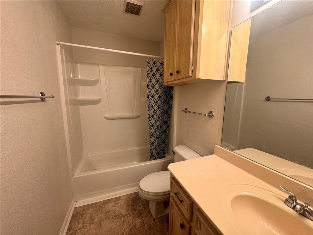 1204 Bayou Woods Drive College Station, TX 77840 - Photo 12 of 14 a bathroom with a sink a toilet and shower