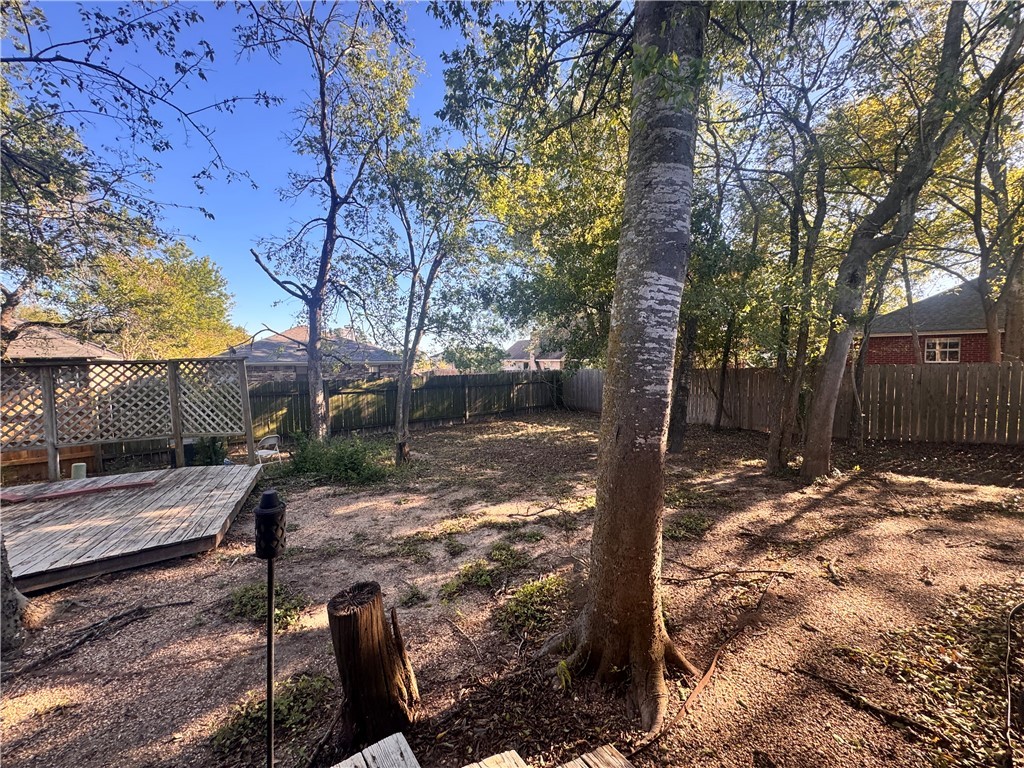 1204 Bayou Woods Drive College Station, TX 77840 - Photo 14 of 14 a view of a backyard with wooden fence