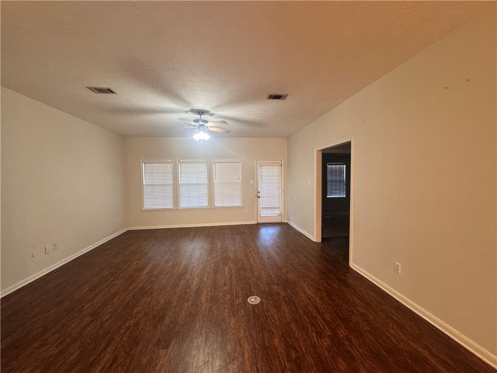 1204 Bayou Woods Drive College Station, TX 77840 - Photo 4 of 14 a view of an empty room with wooden floor and a window